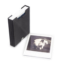 Black 3D printed box for storing Polaroid sx-70, I-type and 600 film. Polaroid of a French bulldog next to box.