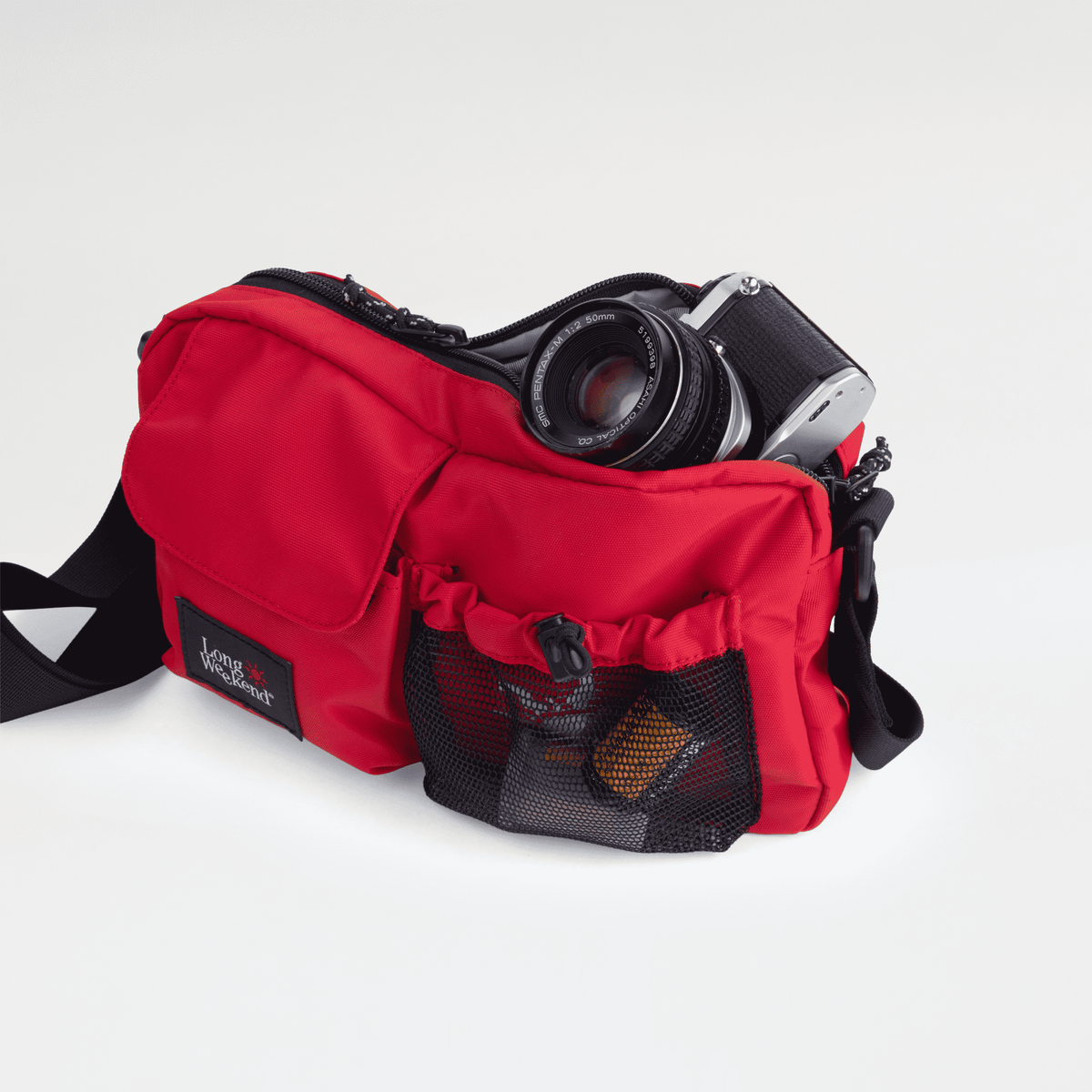 Long Weekend Santa Fe Shoulder Bag in Chili Red, open with a camera inside