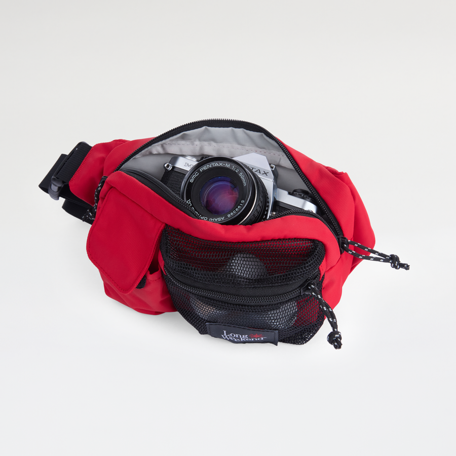 Long Weekend Monterey Sling in Chili Red, open with a camera inside