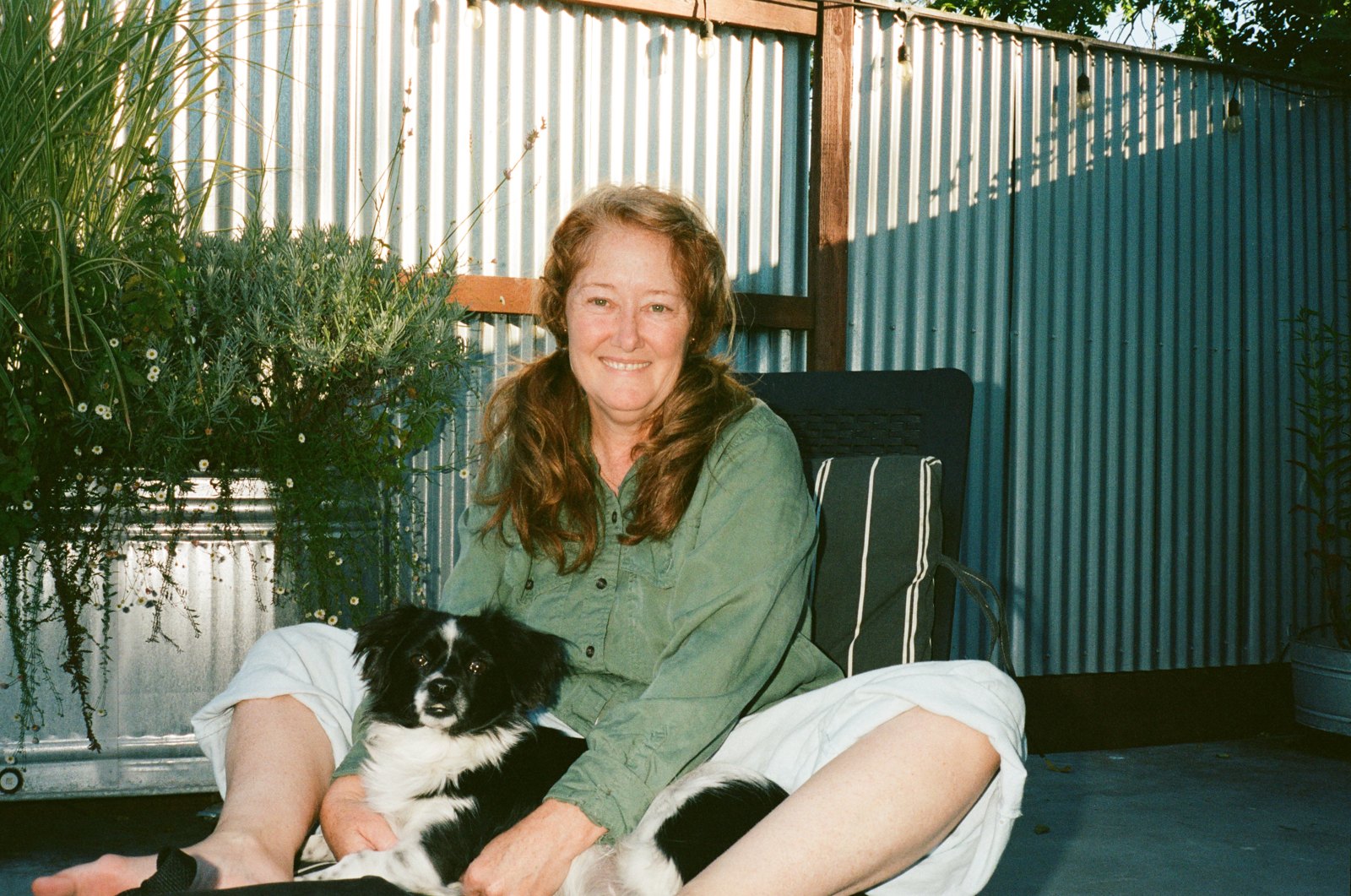 Woman with her dog on a back porch, shot on 35mm